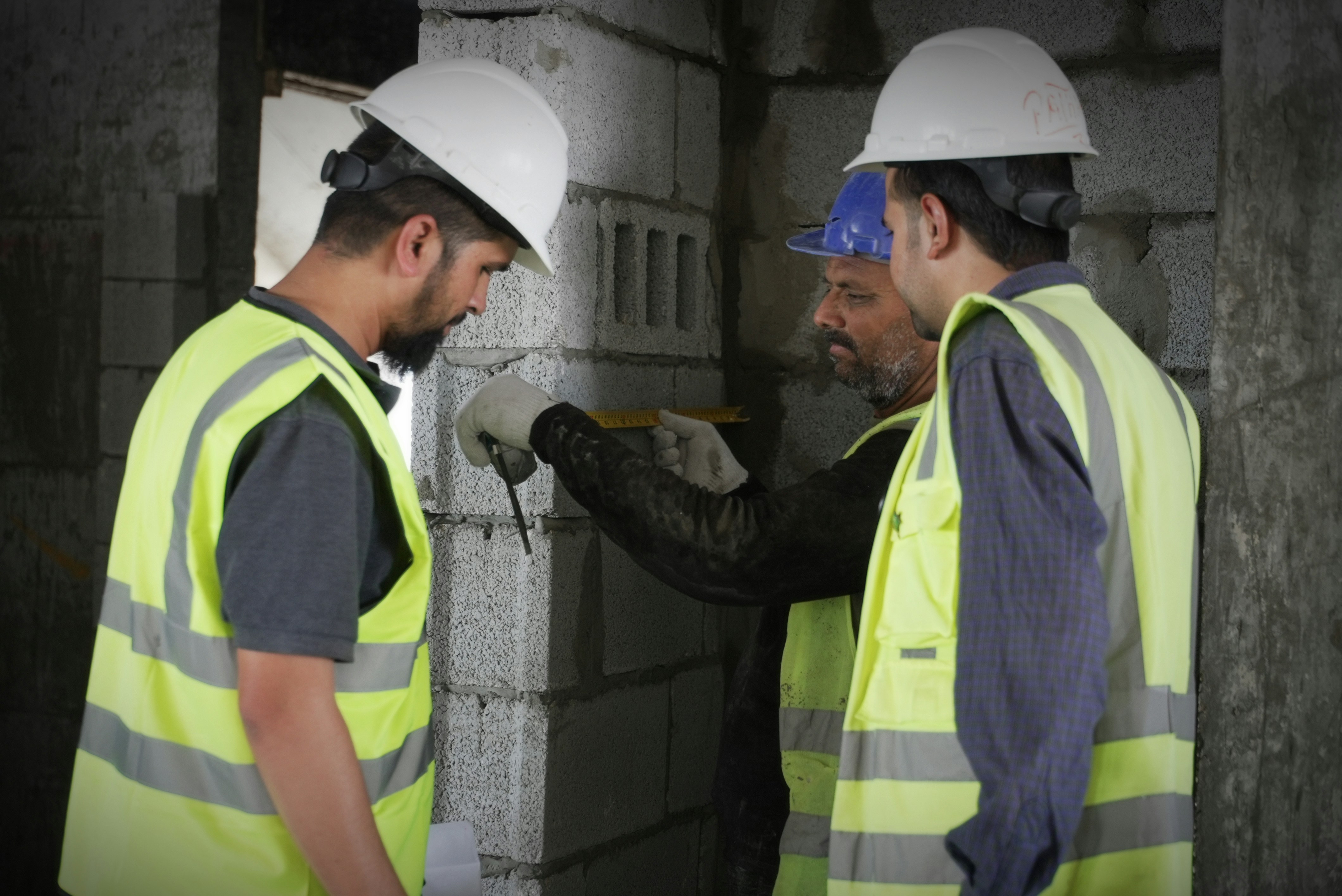 MR Construction team measuring and inspecting site work
